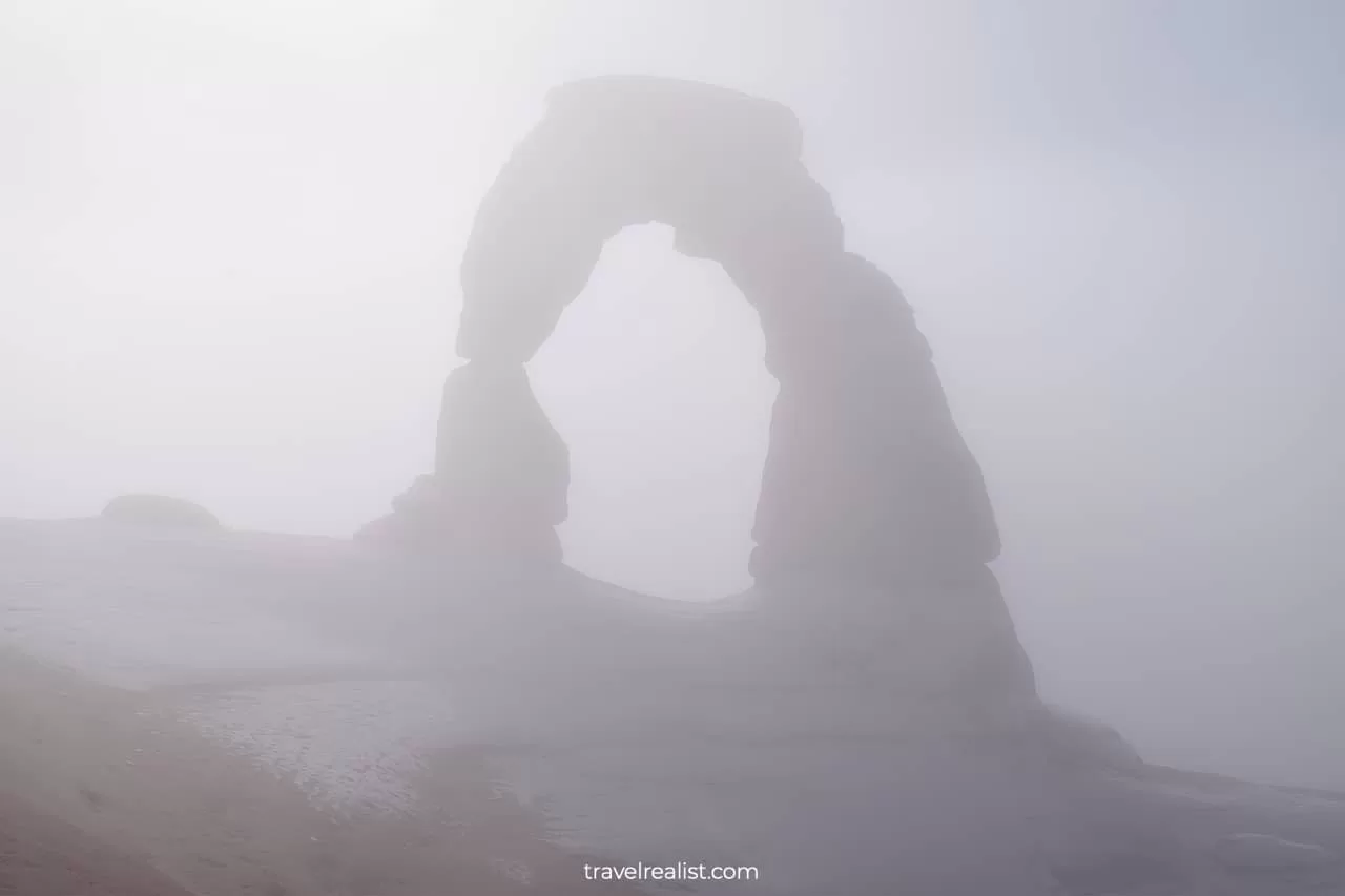 Delicate Arch covered in fog in Arches National Park, Utah, US