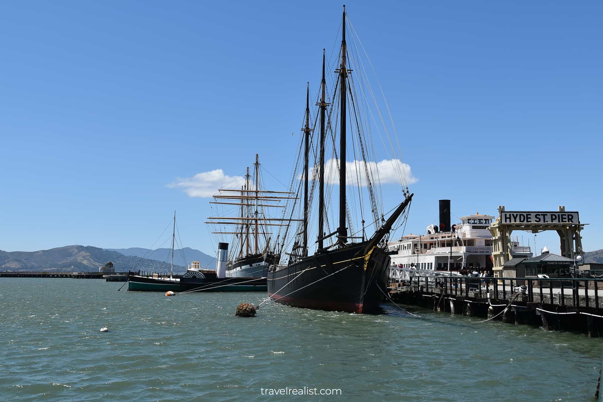 Lumber schooner C.A. Thayer, Paddlewheel tug Eppleton Hall, and Square rig sailing ship Balclutha at Hyde Pier in San Francisco, California, US