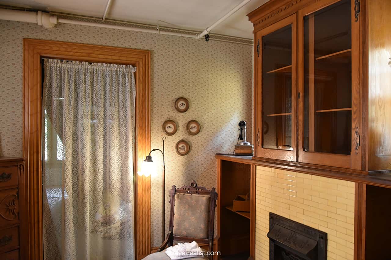 Room with fireplace and wooden furniture in Winchester Mystery House in San Jose, California, US