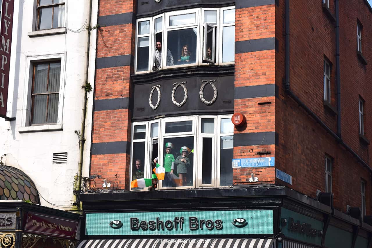 Spectators watching St Patrick's Day Parade from windows in Dublin, Ireland