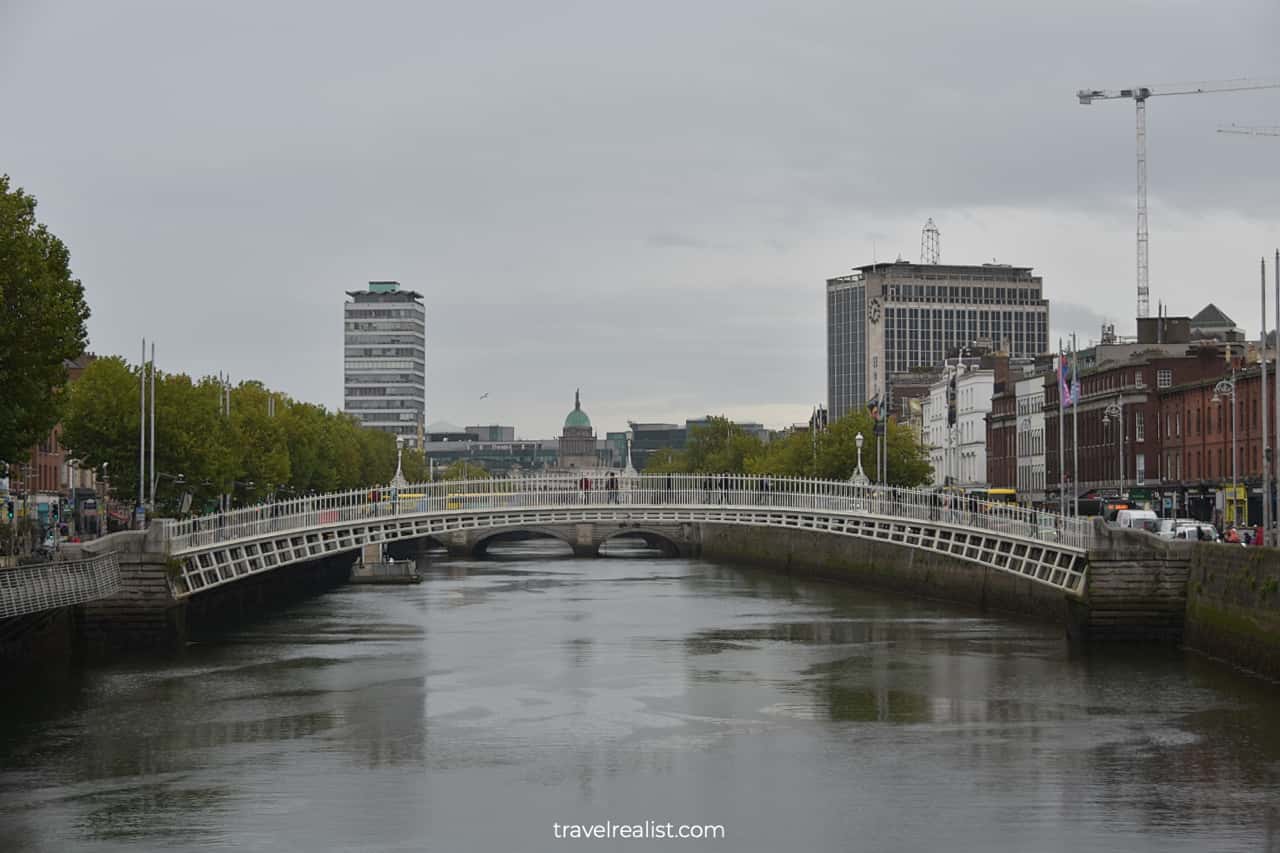 Ha'penny Bridge Bridge and the Custom House in distance in Dublin, Ireland