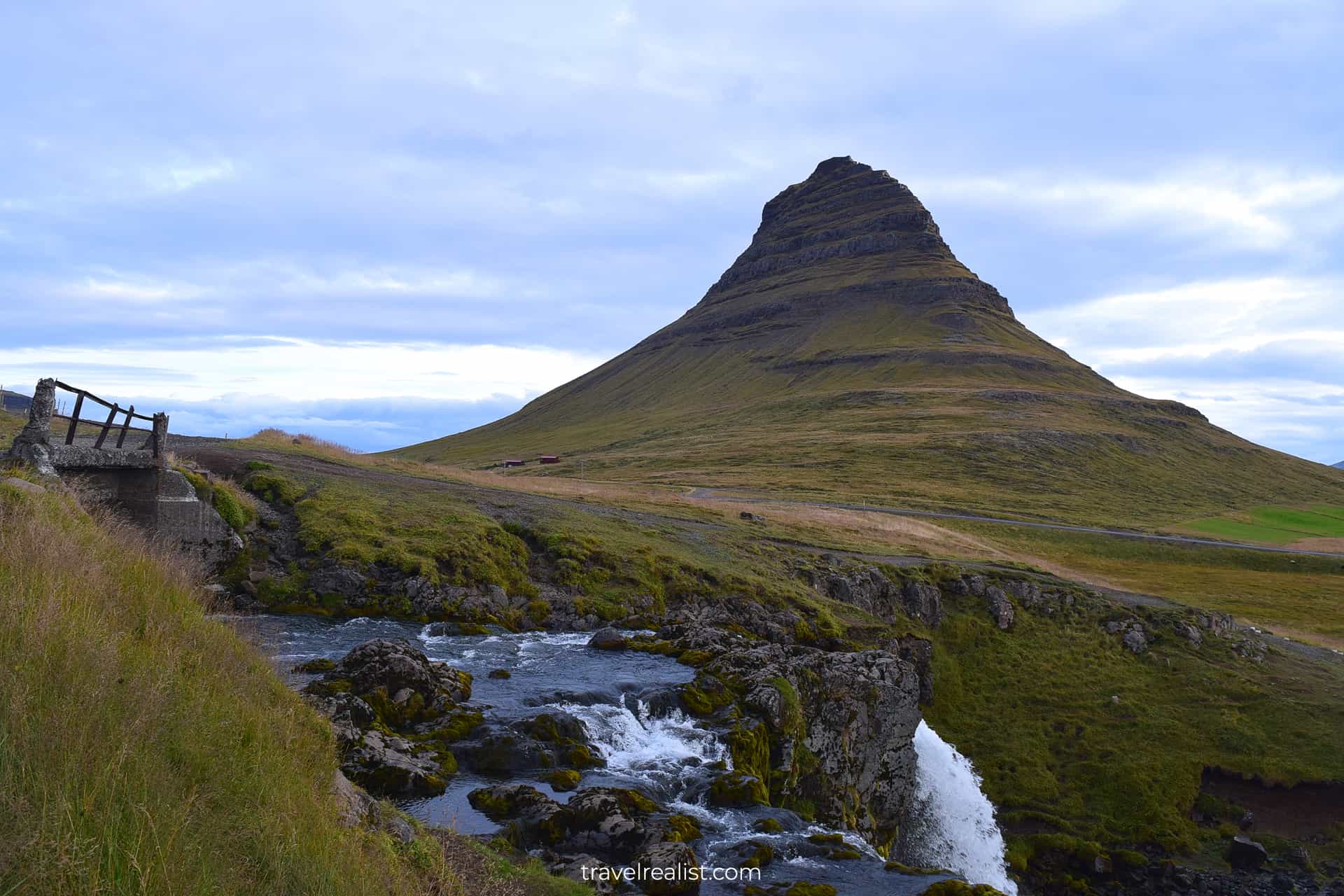 Iconic view of Kirkjufell with waterfall and bridge in Western Region, Iceland