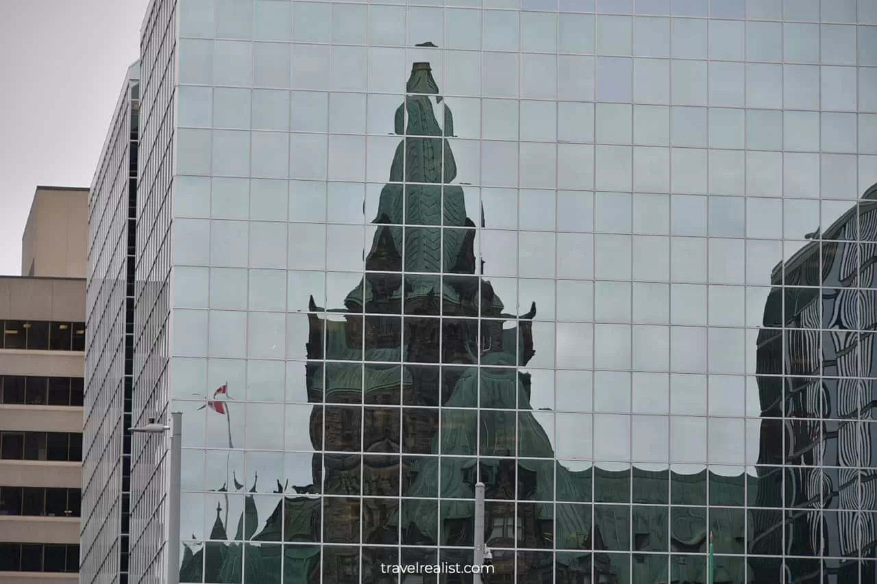 Confederation Building reflections on Bank of Canada Museum building in Ottawa, Ontario, Canada