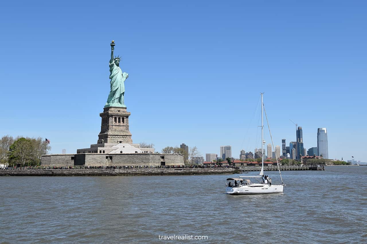 Statue of Liberty and yacht in New York Harbor, US