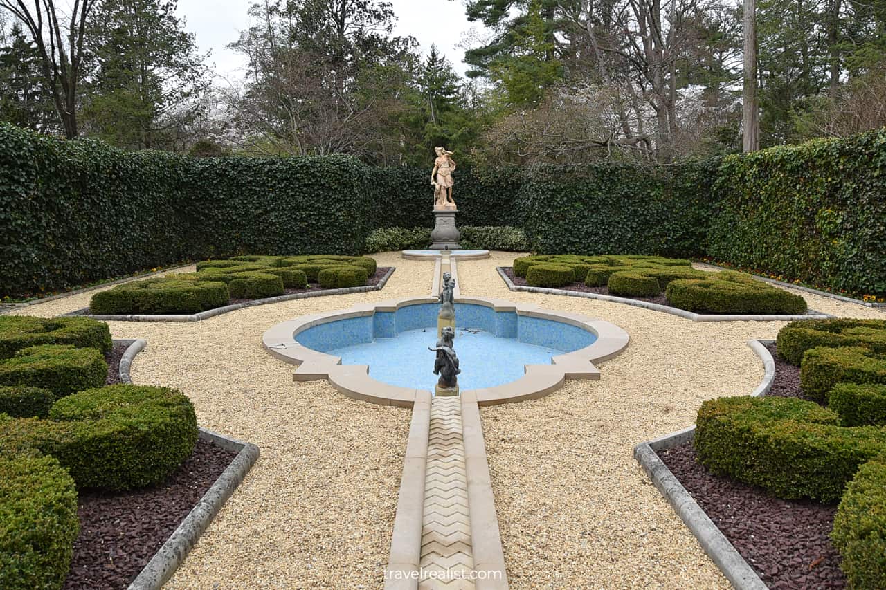 Fountain, statues, and live fence in French Parterre at Hillwood Estate in D.C., United States