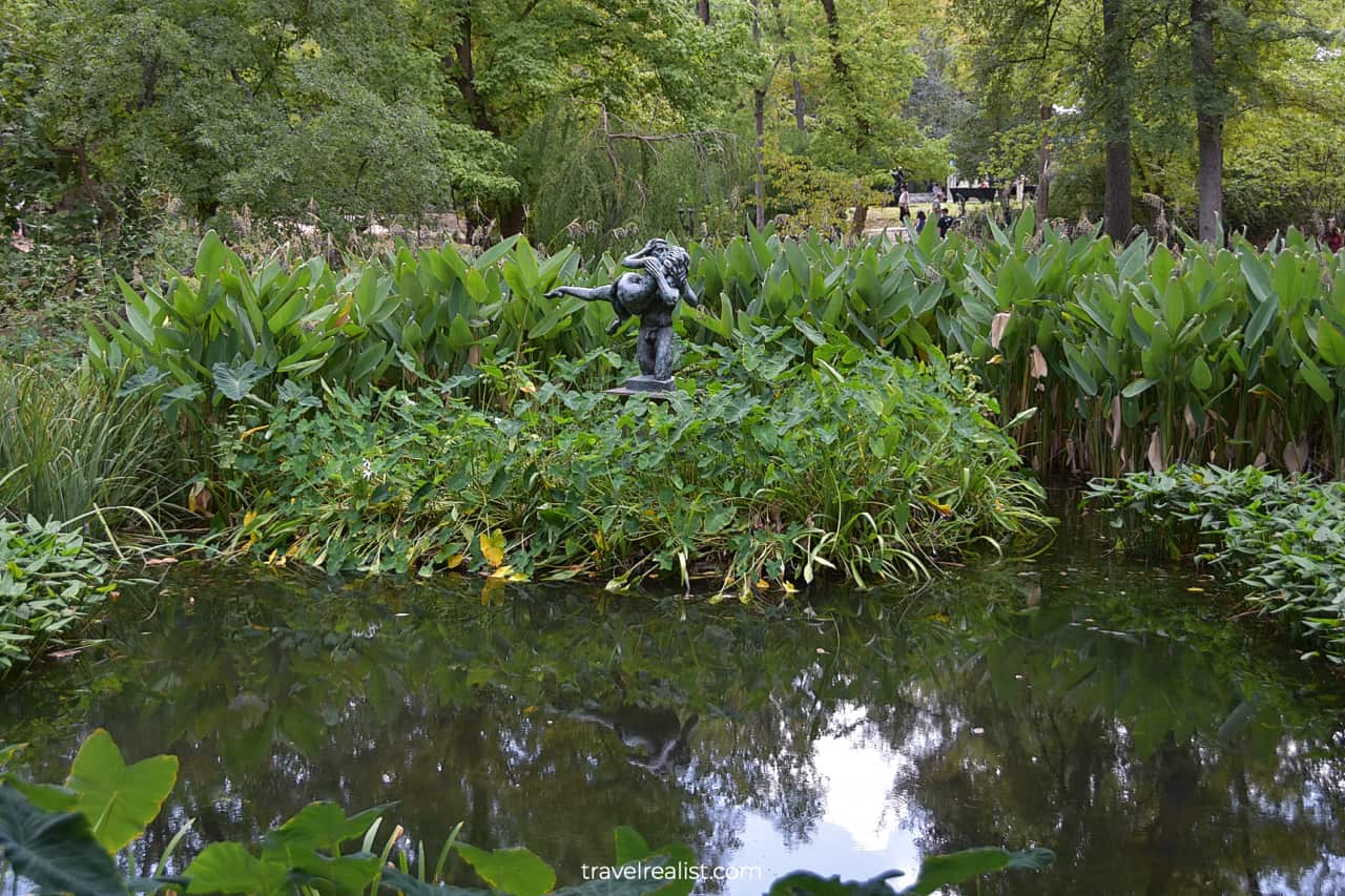 The Kiss sculpture reflections in pond in Umlauf Sculpture Garden & Museum in Austin, Texas