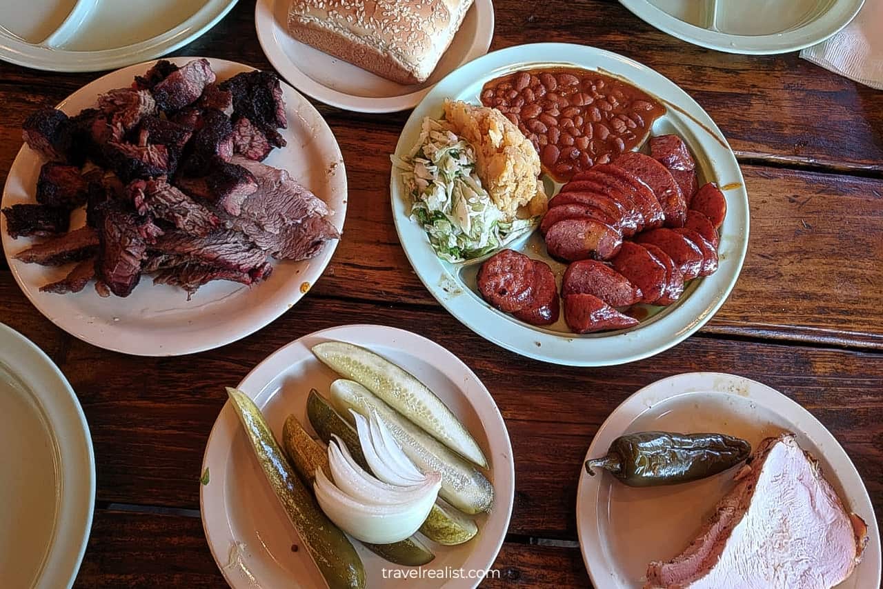 Brisket, sausage plate, turkey, bread, pickles, and onions at Salt Lick BBQ in Driftwood near Austin, Texas, US